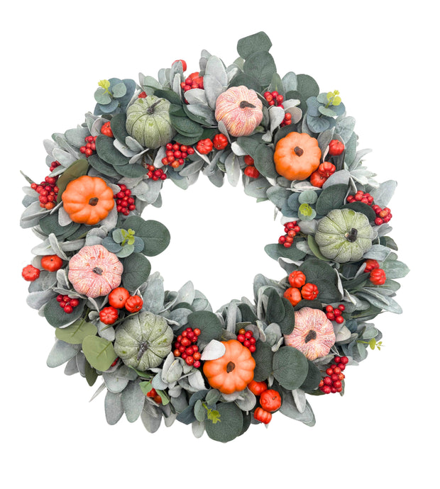 Decorative wreath with pumpkins, berries, and leaves on a white background